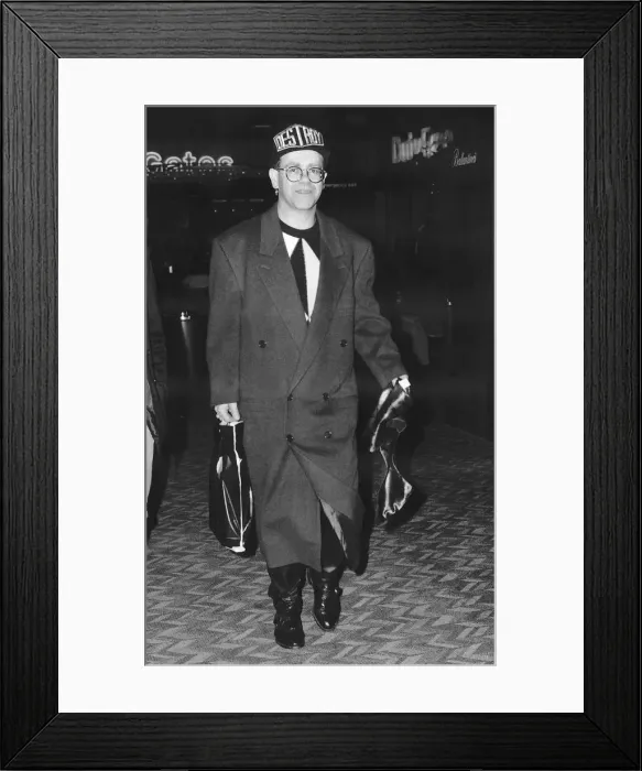 Framed Print : Elton John pop singer at Heathrow Airport on his way to see friends in Canada Framed Print : Elton John pop singer at Heathrow Airport on his way to see friends in Canada