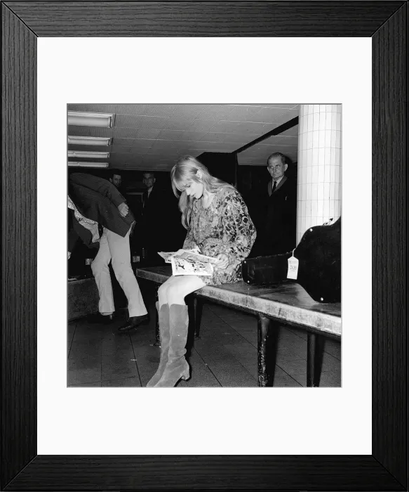 Framed Print : Rolling Stones lead singer Mick Jagger arrives at London Heathrow Airport with Marianne