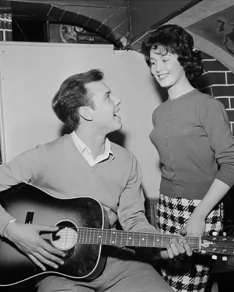 Singer Marty Wilde sings to his fiancee Joyce Baker (18), 28th October 1959