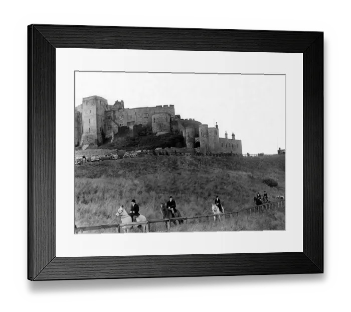 Framed Print : Bamburgh Castle made an impressive background as followers of the Percy Foxhounds moved