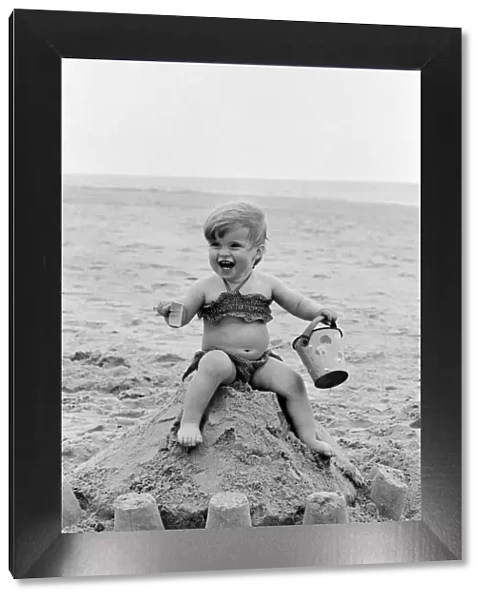 Seventeen month old Sarah Jukes from Wimbledon plays in the sand during a day