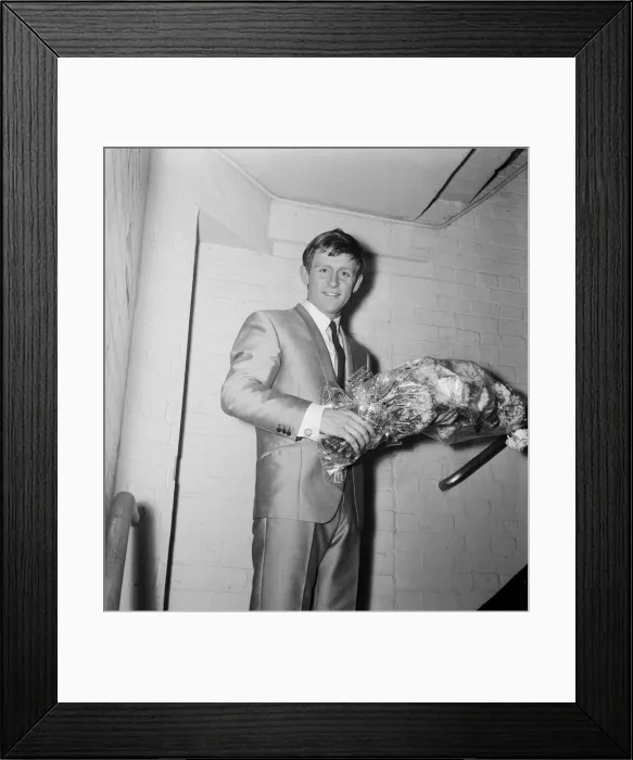 Framed Print : Singer Johnny Leyton holding a bunch of flowers backstage after giving a concert to