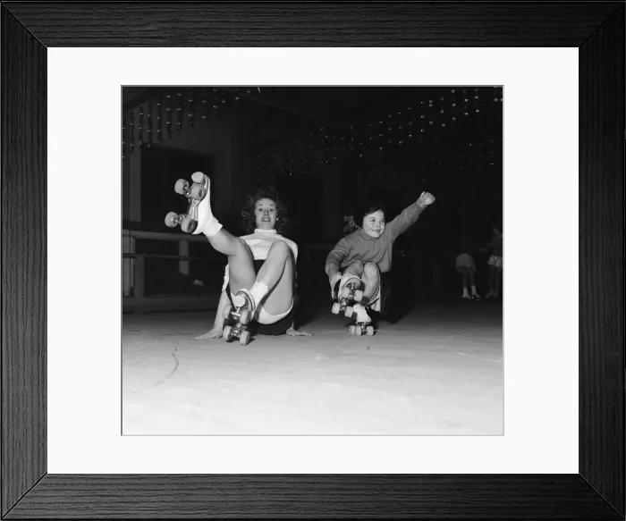 Framed Print : Teenager Betty Jones pictured roller skating with seven year old Anne Morgan at the rink Framed Print : Teenager Betty Jones pictured roller skating with seven year old Anne Morgan at the rink