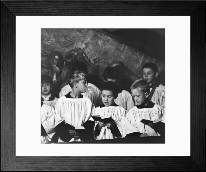 Framed Print : Ten year old choirboy Ian Stacey of Bethnal Green tries to break the concentration of his Framed Print : Ten year old choirboy Ian Stacey of Bethnal Green tries to break the concentration of his