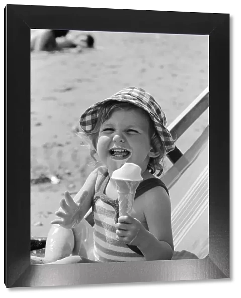 Eighteen month old Nicola England from Bromley, Kent enjoys an ice cream on the beach at
