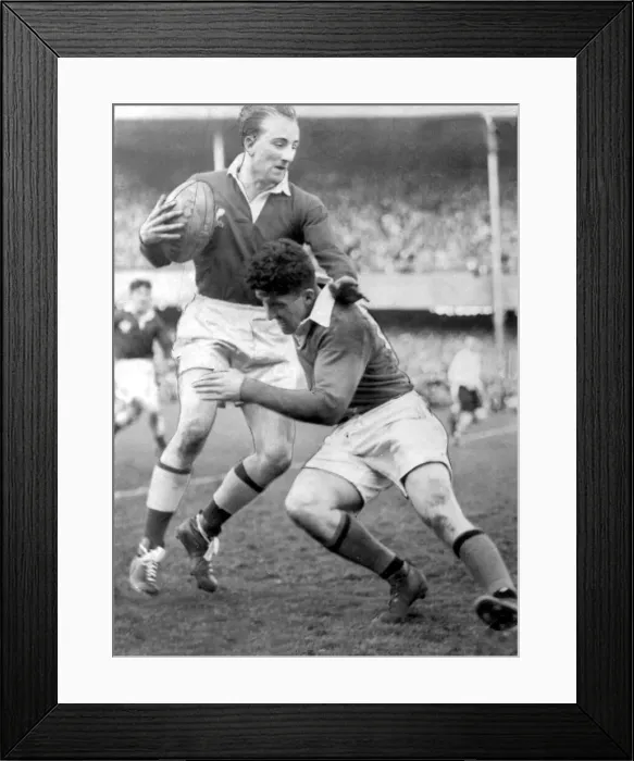 Framed Print : Sport - Rugby - Wales v Ireland - Lewis Jones, the young Welsh full back is seen avoiding