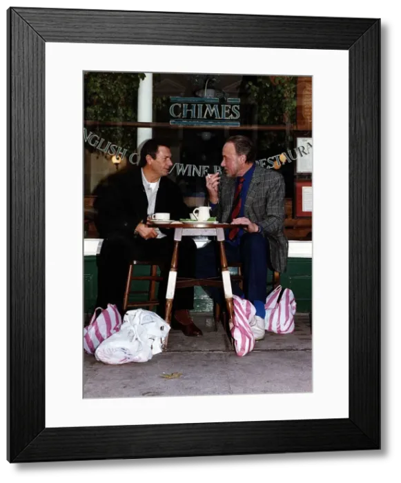 Framed Print : Don Henderson Actor & Michael Elphick actor sitting at pavement cafe table with shopping Framed Print : Don Henderson Actor & Michael Elphick actor sitting at pavement cafe table with shopping