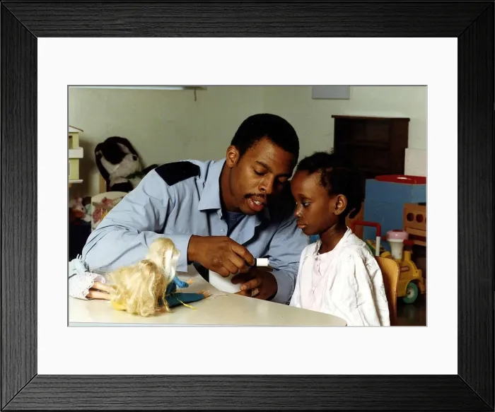 Framed Print : Trevor Etienne actor with a young child A©Mirrorpix