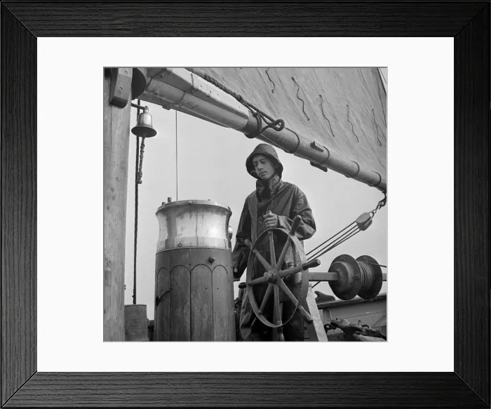 Framed Print : A student attending the Outward Bound Sea School at Aberdovey seen here steering Framed Print : A student attending the Outward Bound Sea School at Aberdovey seen here steering