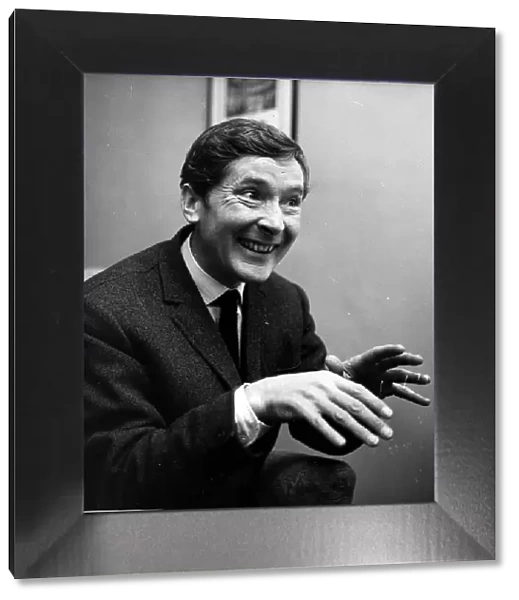 Kenneth Williams comedian hands held out in front in agents office Cork St December