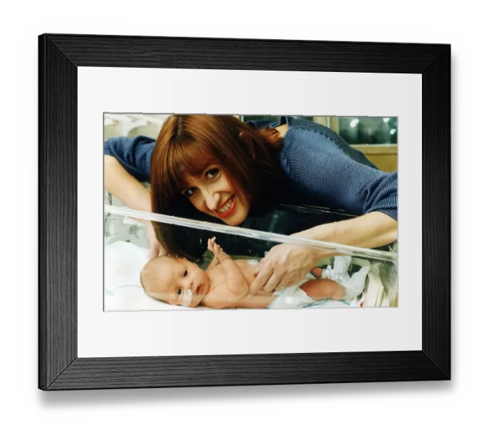 Framed Print : TV presenter Jackie Bird holding her baby March 1995 Framed Print : TV presenter Jackie Bird holding her baby March 1995