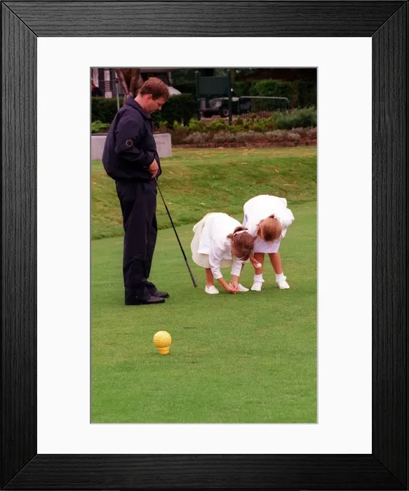 Framed Print : Prince Andrew and daughters Beatrice (R) and Eugenie, August 1998 Placing a golf