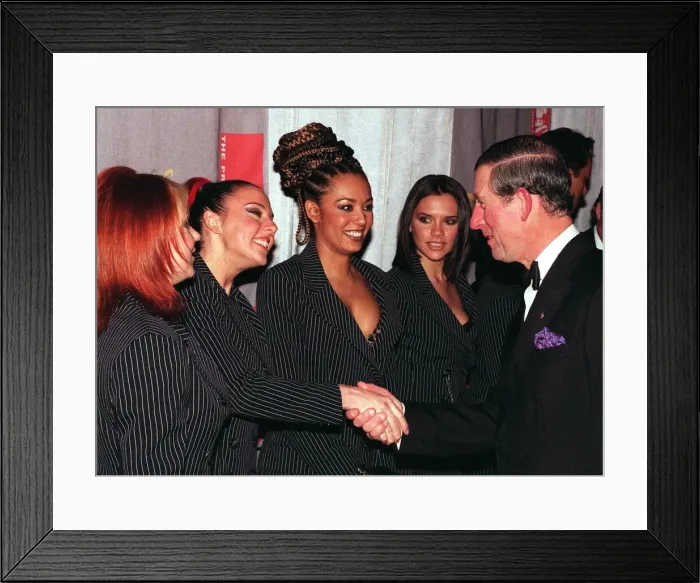 Framed Print : Spice Girls Geri Halliwell, Mel B and Victoria Adams look on as Mel C shakes hands with Framed Print : Spice Girls Geri Halliwell, Mel B and Victoria Adams look on as Mel C shakes hands with