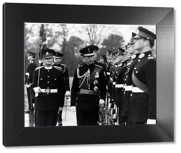 Prince Charles inspects a guard of honour at Sandhurst in uniform December 1978