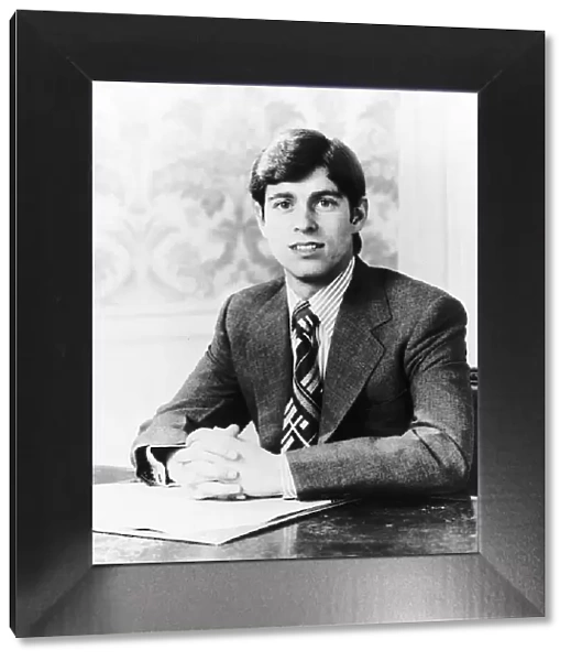 Prince Andrew sitting at a desk with hands together September 1979