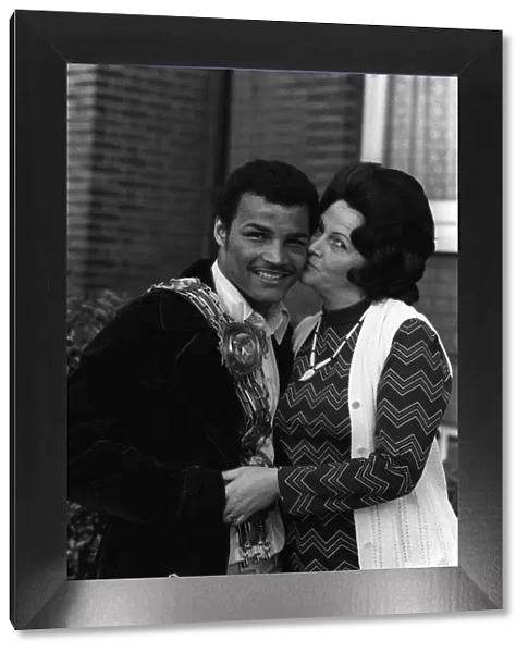 John Conteh gets a kiss from his mother after winning the British