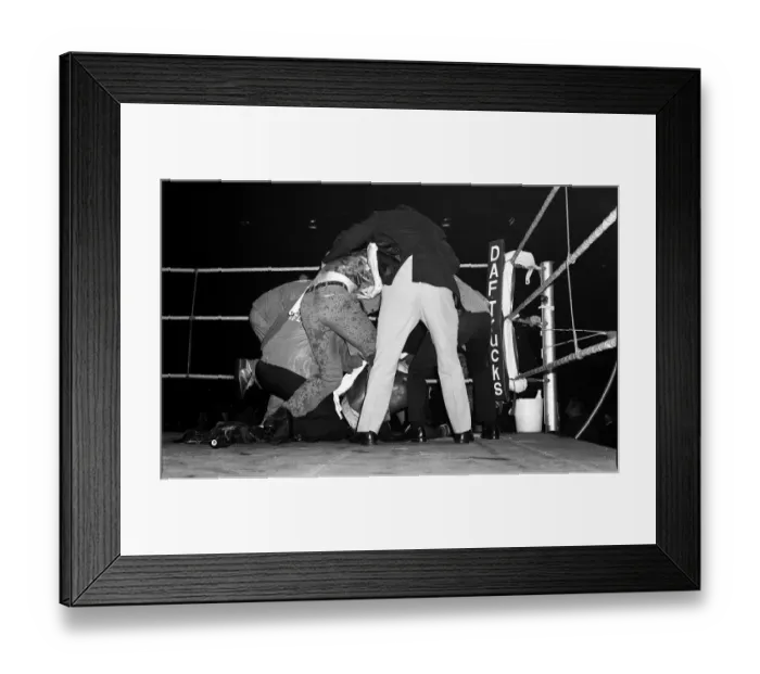 Framed Print : Marvin Hagler is shielded from bottles by referee 1980 after beating Alan Minter in Framed Print : Marvin Hagler is shielded from bottles by referee 1980 after beating Alan Minter in