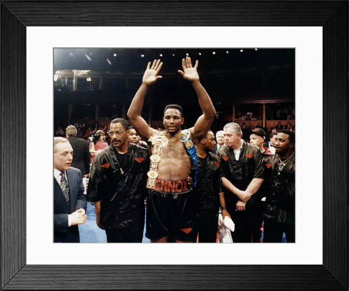 Framed Print : Lennox Lewis Boxer raises his hands with his belts on her shoulders after beating Derek Framed Print : Lennox Lewis Boxer raises his hands with his belts on her shoulders after beating Derek
