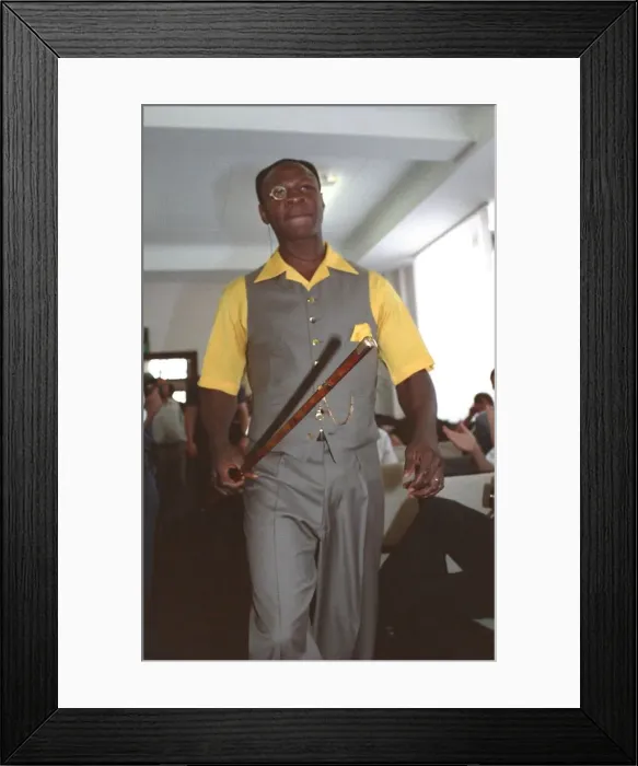 Framed Print : Chris Eubank Boxing in grey waist coat and trousers and yellow short sleeve shirt struts Framed Print : Chris Eubank Boxing in grey waist coat and trousers and yellow short sleeve shirt struts