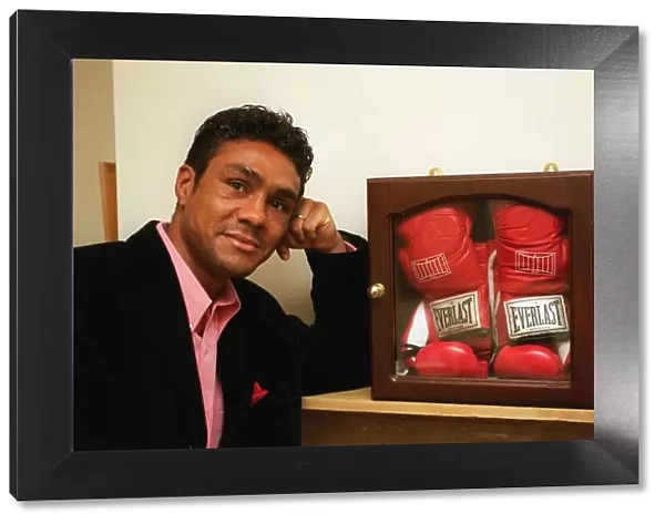 Boxer Kevin Lveshing at home in Westerham standing in front of cased boxers gloves