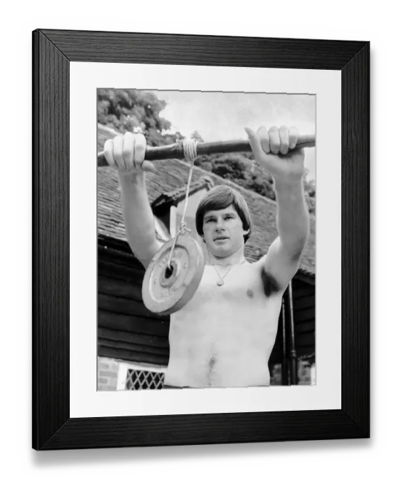 Framed Print : Nick Faldo Golf stands bare chested as he exercises his wrists by holding a weight Framed Print : Nick Faldo Golf stands bare chested as he exercises his wrists by holding a weight