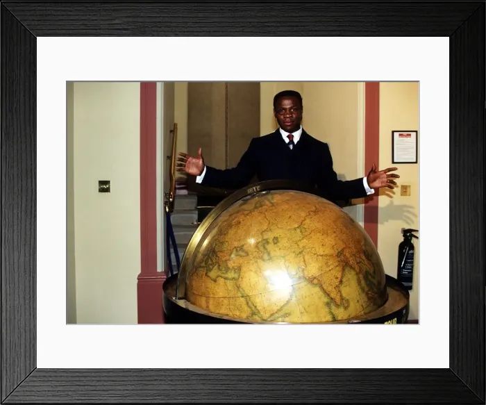 Framed Print : Chris Eubank standing behind a globe Framed Print : Chris Eubank standing behind a globe