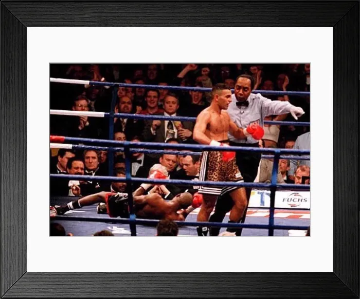 : The referee leads Prince Naseem Hamed to his corner after knocking Tom Boom Boom Johnson : The referee leads Prince Naseem Hamed to his corner after knocking Tom Boom Boom Johnson
