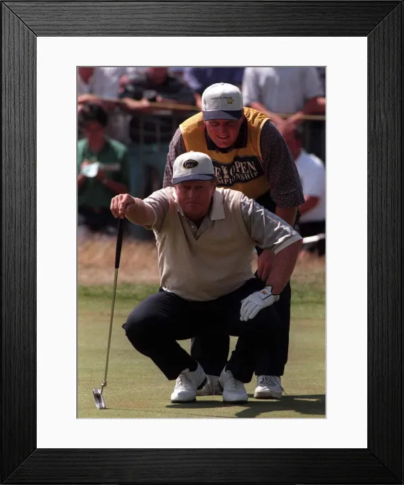 Framed Print : Jack Nicklaus Golfer measures up the line of play with his son Steve on the 18th green