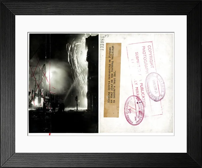 Framed Print : Blazing debris descending on firemen as they play on the burning buildings in London