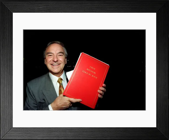 Framed Print : Bob Monkhouse Comedian / TV Presenter holding the book of gags that was stolen from his Framed Print : Bob Monkhouse Comedian / TV Presenter holding the book of gags that was stolen from his