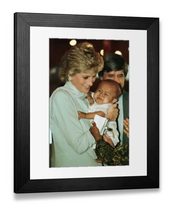 Framed Print : Diana, Princess of Wales holding a baby during prize giving ceremonies on a visit to