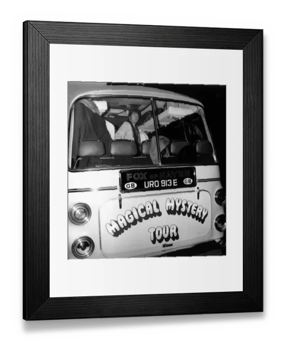 Framed Print : John lennon looks out of the back window of the Magical Mystery Tour Bus as The Beatles