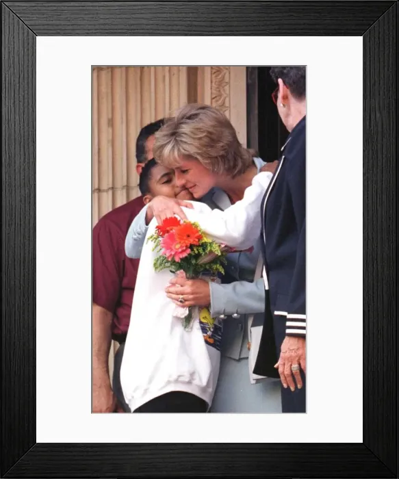 Framed Print : Diana, Princess of Wales, hugs a young girl who gave her flowers as she leaves Cook Framed Print : Diana, Princess of Wales, hugs a young girl who gave her flowers as she leaves Cook