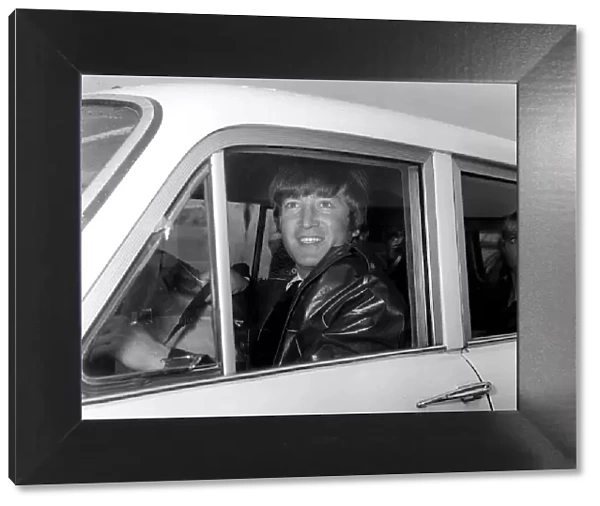 John Lennon pictured on his arrival back at London Airport, from the groups holidays