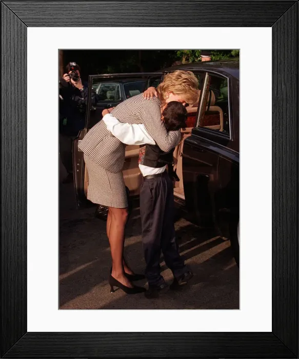 Framed Print : Princess Diana hugging Laurence Chambers who showed her around the Institute for
