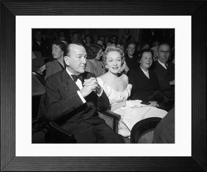 Framed Print : Marlene Dietrich sitting in the stalls of the Globe Theatre with Noel Coward whose play