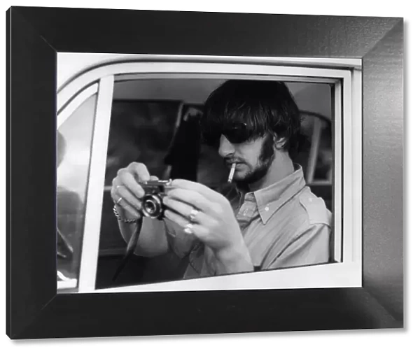Ringo Starr drummer with The Beatles pictured with camera, on holiday in Tobago