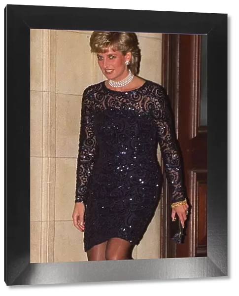 Princess Diana, wearing a black lace dress, leaves the Royal Albert Hall after attending