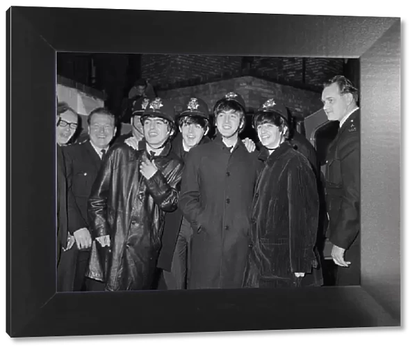The Beatles pop group pose with a group of policemen in Birmingham