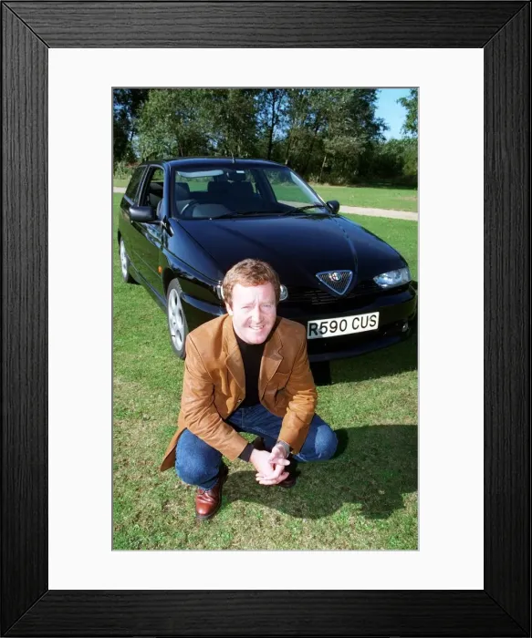Framed Print : Actor Jonathan Watson September 1997 after testing ALFA ROMEO 145 kneeling in front of Framed Print : Actor Jonathan Watson September 1997 after testing ALFA ROMEO 145 kneeling in front of