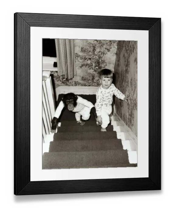 Framed Print : A small boy climbs the stairs to go to bed wearing his pyjamas