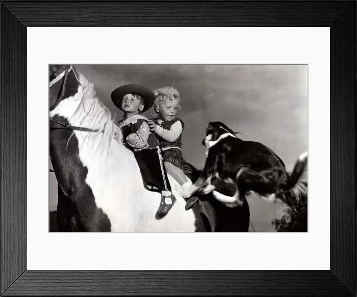 Framed Print : Boy and girl on horse as dog jumps on - October 1953 David Sutton dressed as cowboy Framed Print : Boy and girl on horse as dog jumps on - October 1953 David Sutton dressed as cowboy