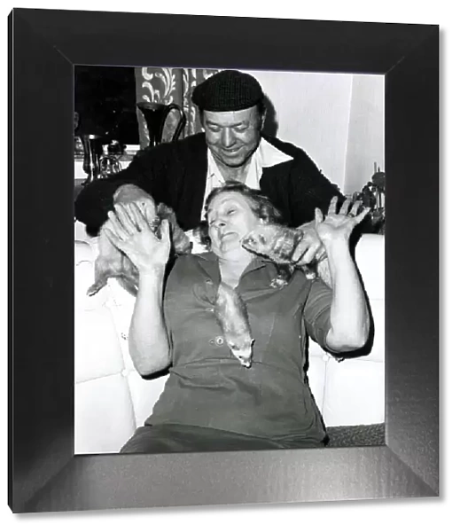 Eric and Queenie Robinson play with their pet Ferret s