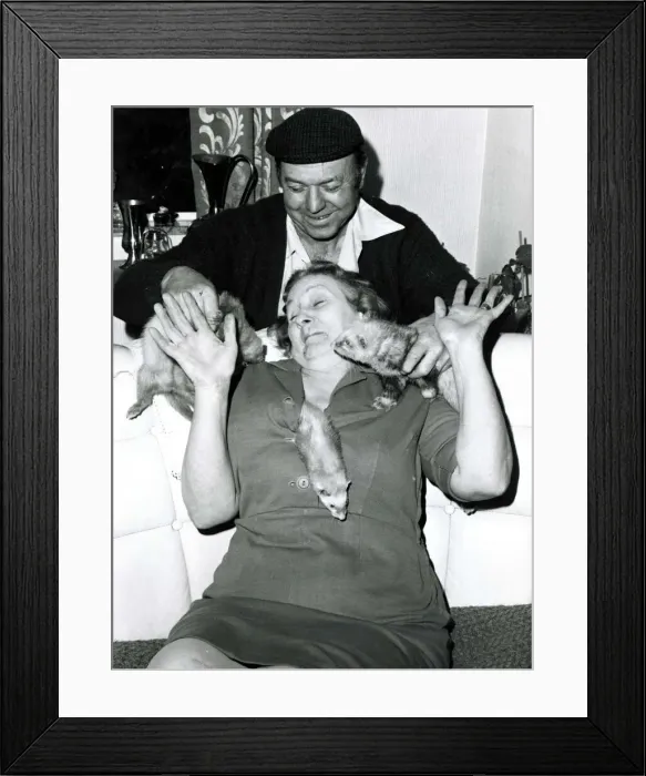 Framed Print : Eric and Queenie Robinson play with their pet Ferret s Framed Print : Eric and Queenie Robinson play with their pet Ferret s