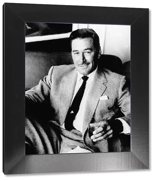 Errol Flynn Actor- September 1977 sitting in a chair with a glass in his