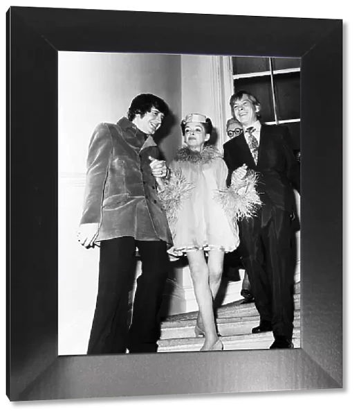 Judy Garland Actress and her new husband Mickey Deans walk down the stairs at Quaglinos