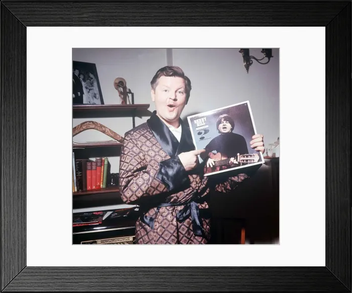 Framed Print : Comedy actor Benny Hill in his Kensington flat February 1966 holding a record Framed Print : Comedy actor Benny Hill in his Kensington flat February 1966 holding a record