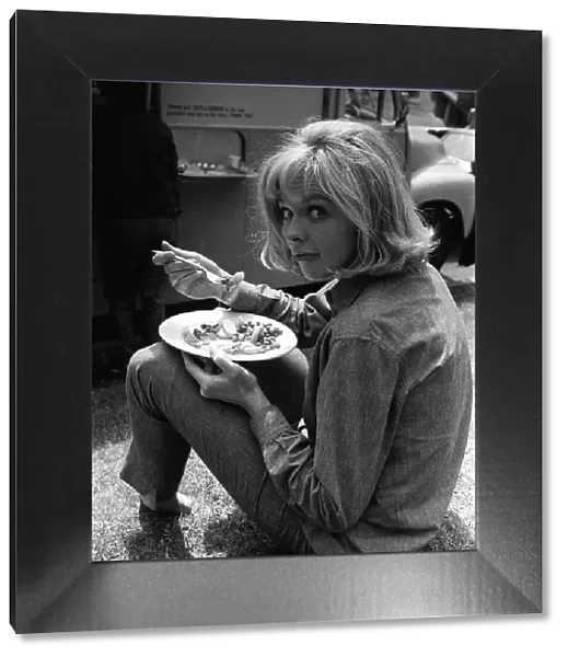 Susannah York takes a lunch break during the filming of scruggs shot outside block of