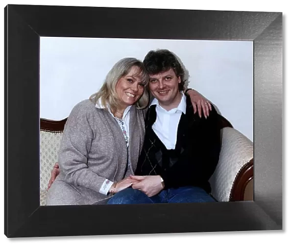 Wendy Richard & husband April 1989 sitting on a sofa, posing for the camera