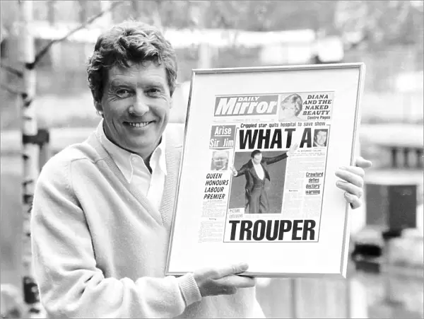 Michael Crawford holds up a framed front page of the Daily Mirror June 1987
